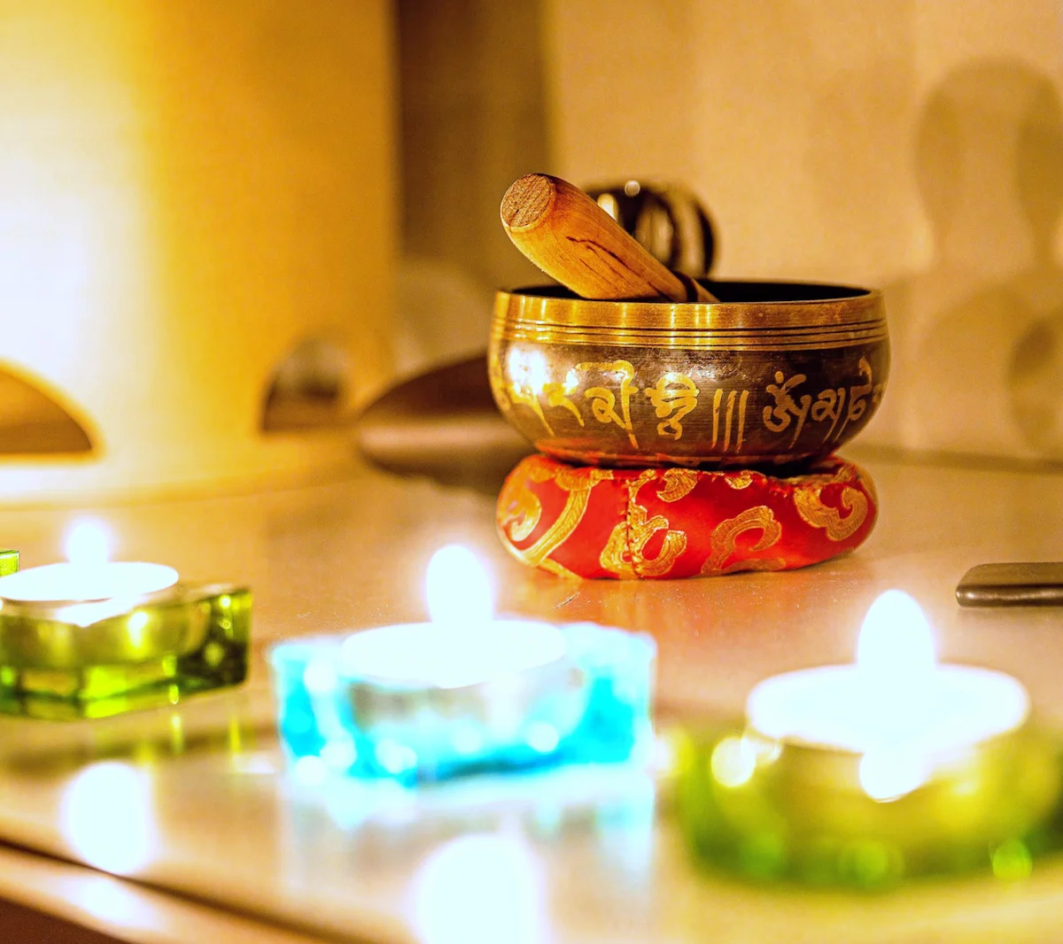 Tibetan singing bowl with coloured candles — The Wild Nest, Ferrara
